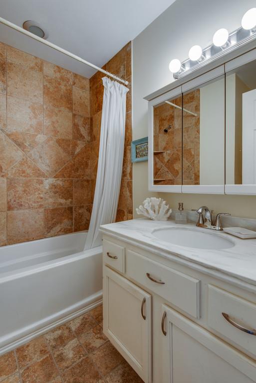 1056 General George Patton Road, Unit 1056 Nashville, TN 37221 - Photo 24 of 30 a bathroom with a granite countertop sink and a mirror