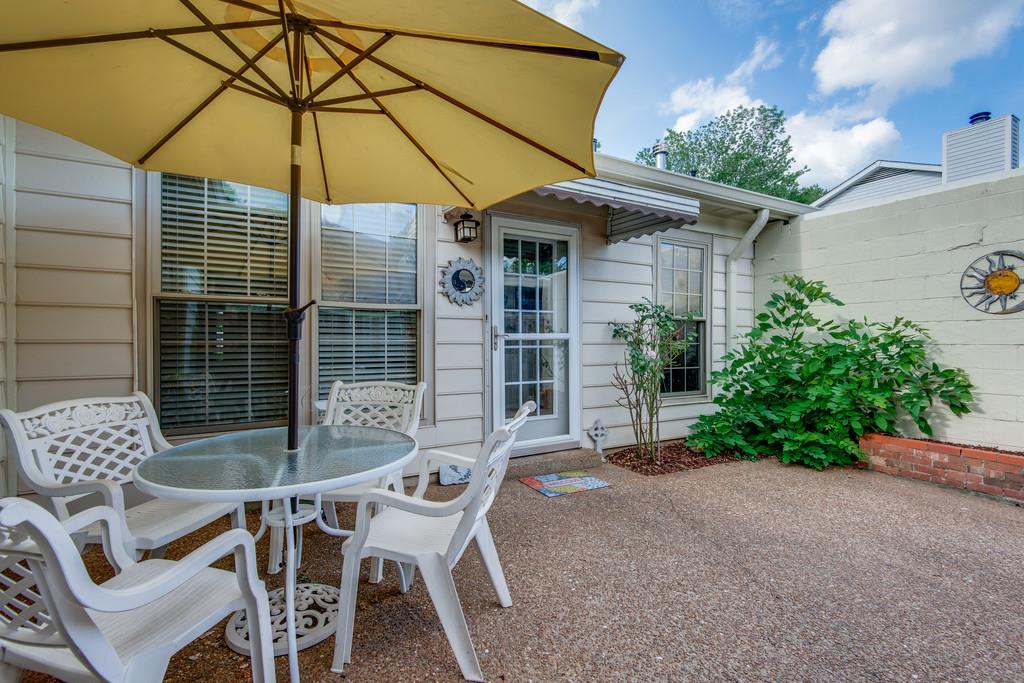1056 General George Patton Road, Unit 1056 Nashville, TN 37221 - Photo 26 of 30 a patio with a table and chairs under an umbrella