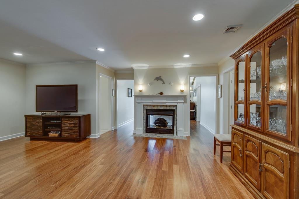 1056 General George Patton Road, Unit 1056 Nashville, TN 37221 - Photo 7 of 30 a living room with furniture a flat screen tv and a fireplace