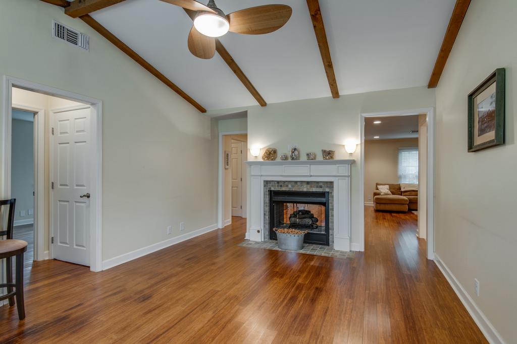 1056 General George Patton Road, Unit 1056 Nashville, TN 37221 - Photo 9 of 30 a living room with wooden floor and a fireplace