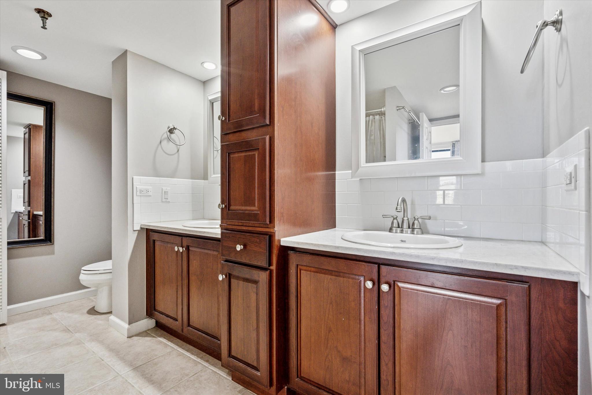 2001 Hamilton Street, Unit 1205 Philadelphia, PA 19130 - Photo 14 of 34 a bathroom with a granite countertop sink and a mirror