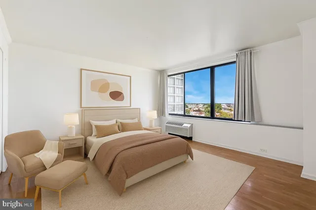 a bathroom with a granite countertop sink mirror vanity and toilet