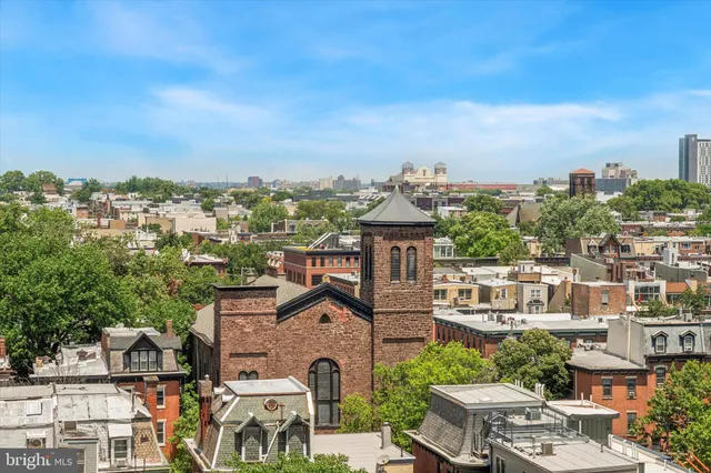 an aerial view of residential houses with city view