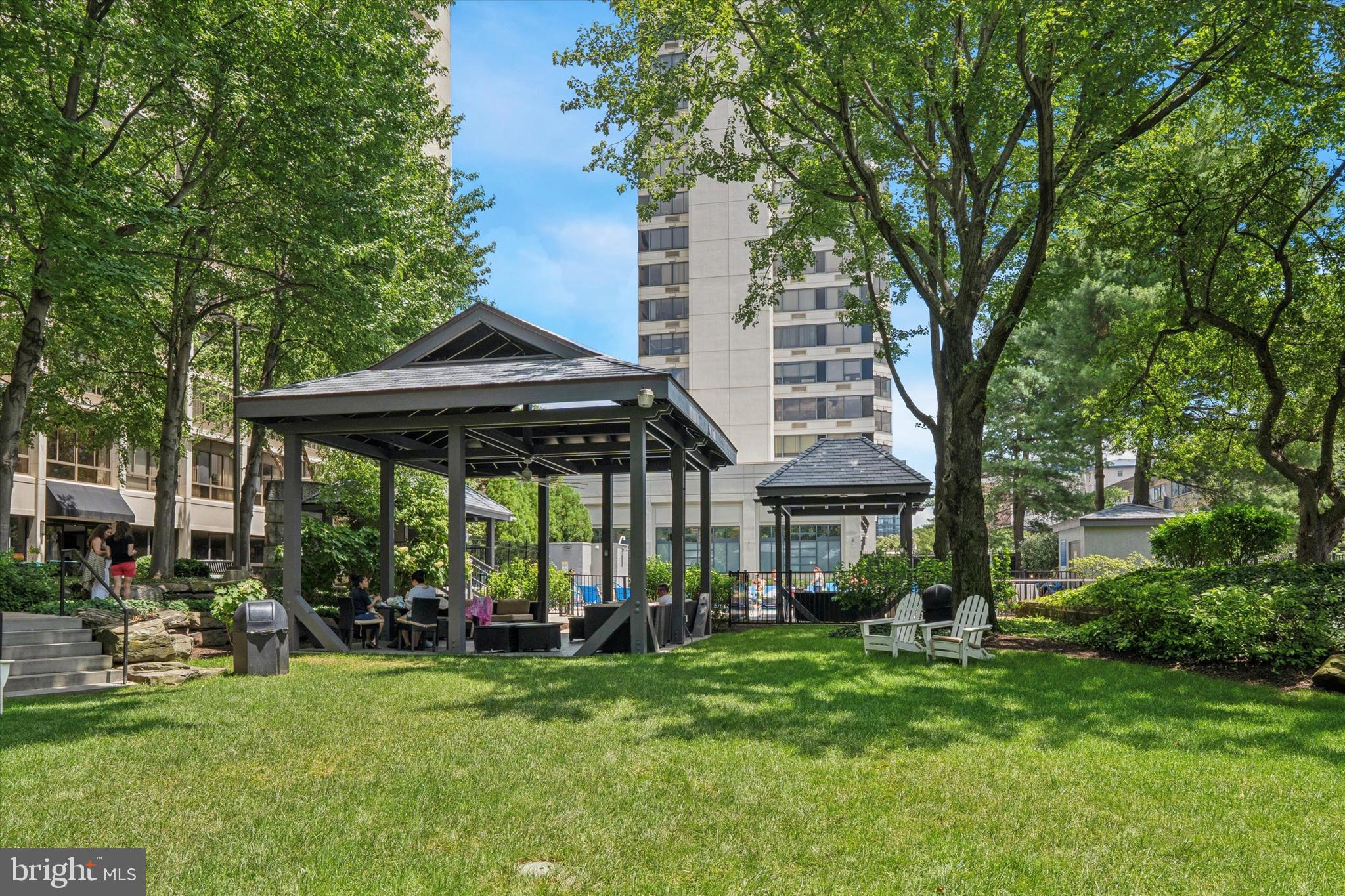 2001 Hamilton Street, Unit 1205 Philadelphia, PA 19130 - Photo 26 of 34 a view of a patio with table and chairs under an umbrella