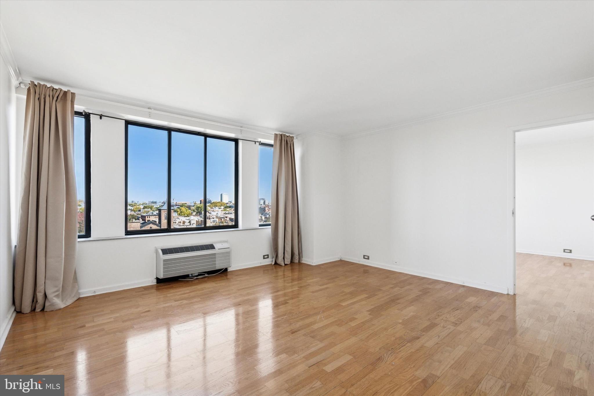 2001 Hamilton Street, Unit 1205 Philadelphia, PA 19130 - Photo 5 of 34 a view of an empty room with a window