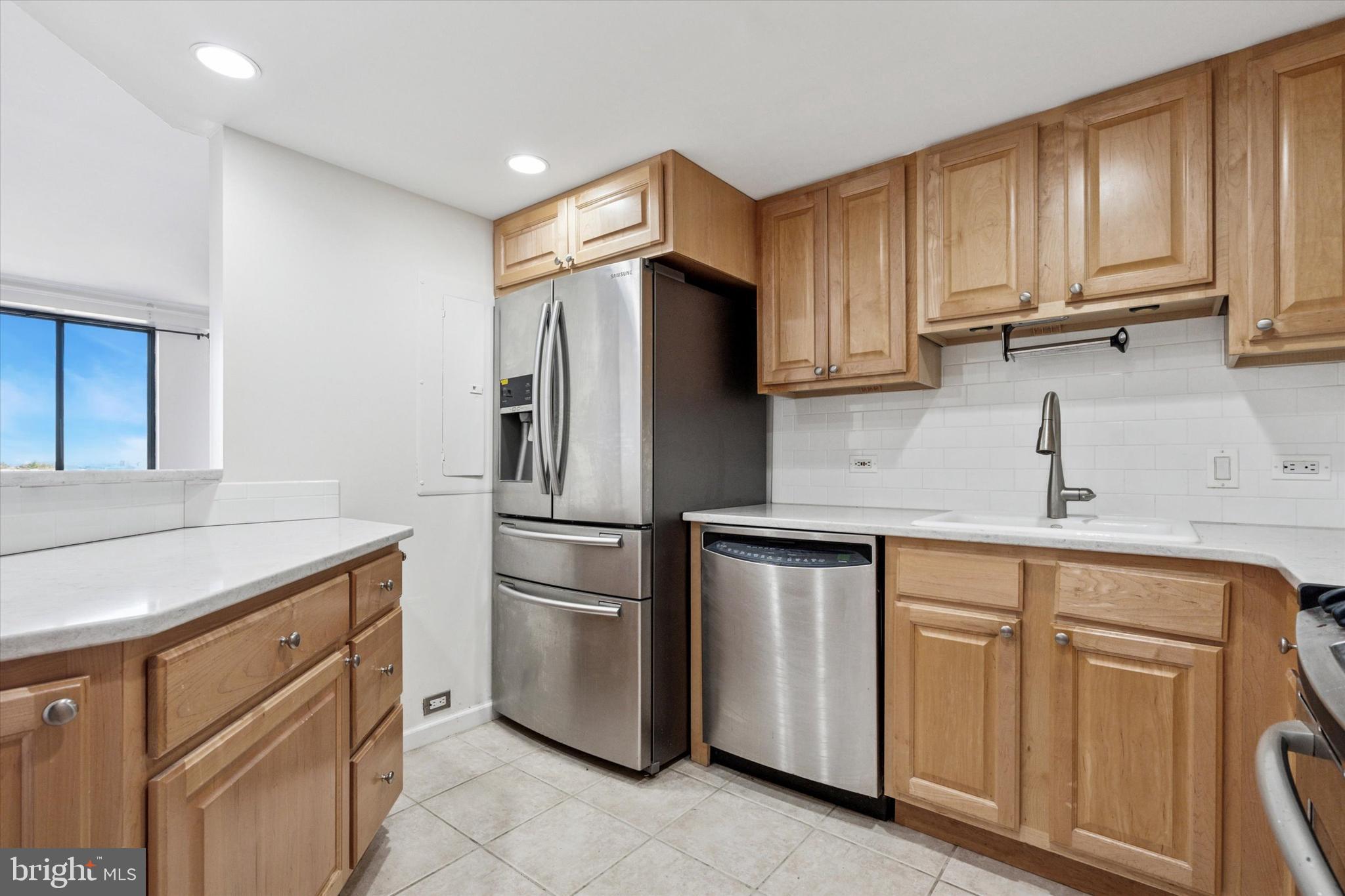 2001 Hamilton Street, Unit 1205 Philadelphia, PA 19130 - Photo 8 of 34 a kitchen with white cabinets and refrigerator