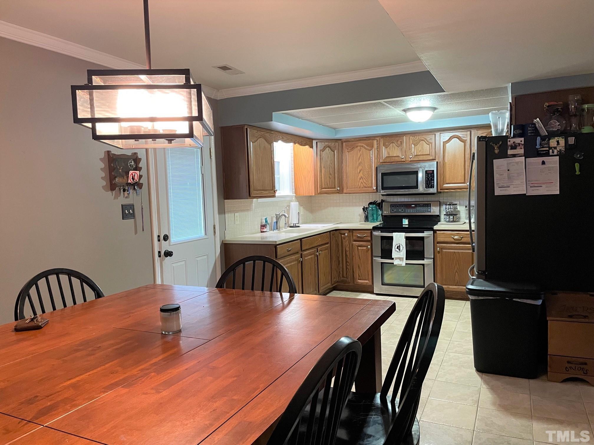 1641 Oak Grove Road Roxboro, NC 27574 - Photo 2 of 23 a kitchen with kitchen island a dining table and chairs