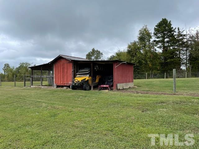 1641 Oak Grove Road Roxboro, NC 27574 - Photo 19 of 23 a view of a wooden house with a big yard and large trees