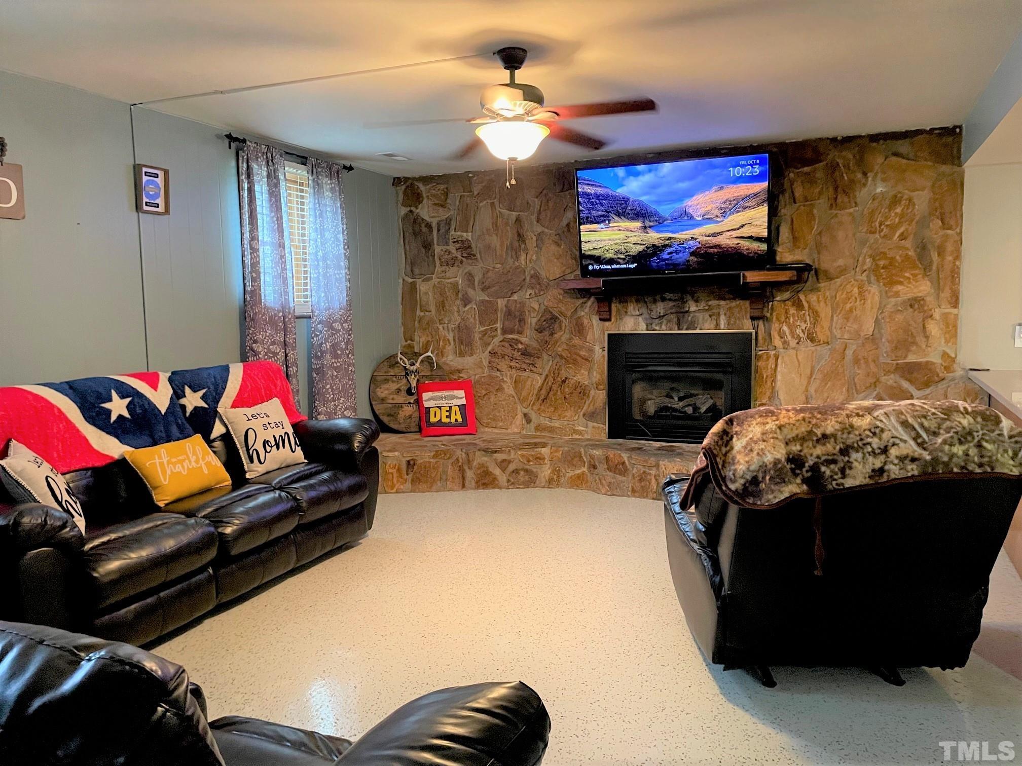 1641 Oak Grove Road Roxboro, NC 27574 - Photo 3 of 23 a living room with furniture a flat screen tv and a fireplace
