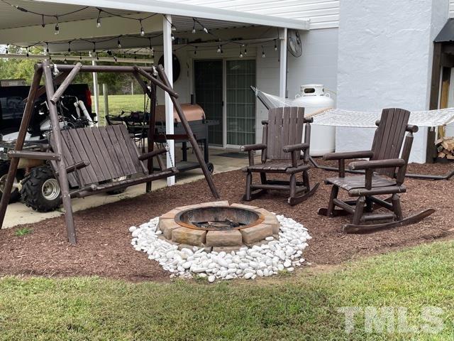 1641 Oak Grove Road Roxboro, NC 27574 - Photo 22 of 23 a view of a house with backyard water fountain and sitting area