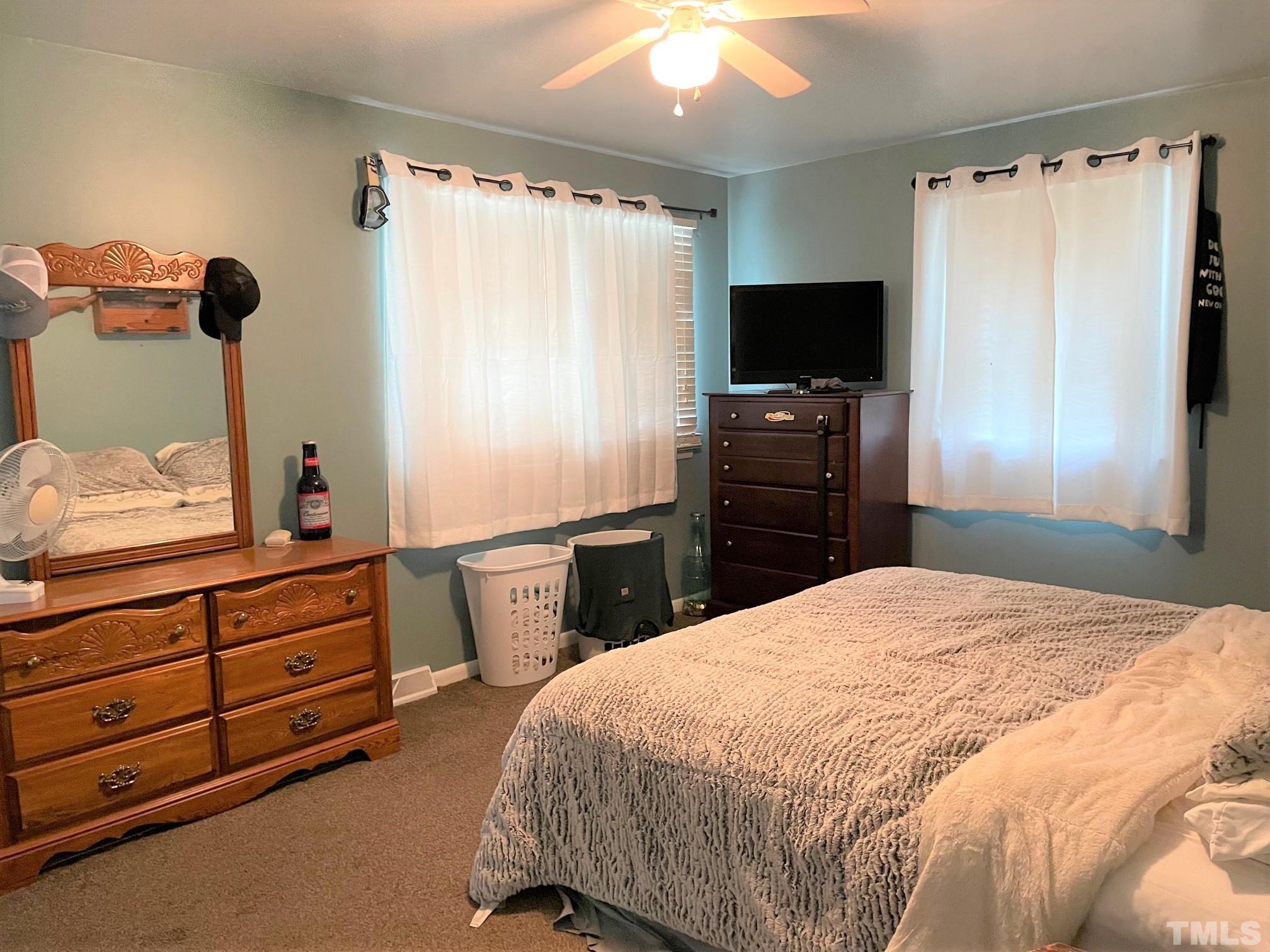 1641 Oak Grove Road Roxboro, NC 27574 - Photo 7 of 23 a bedroom with a bed and a flat tv screen in it