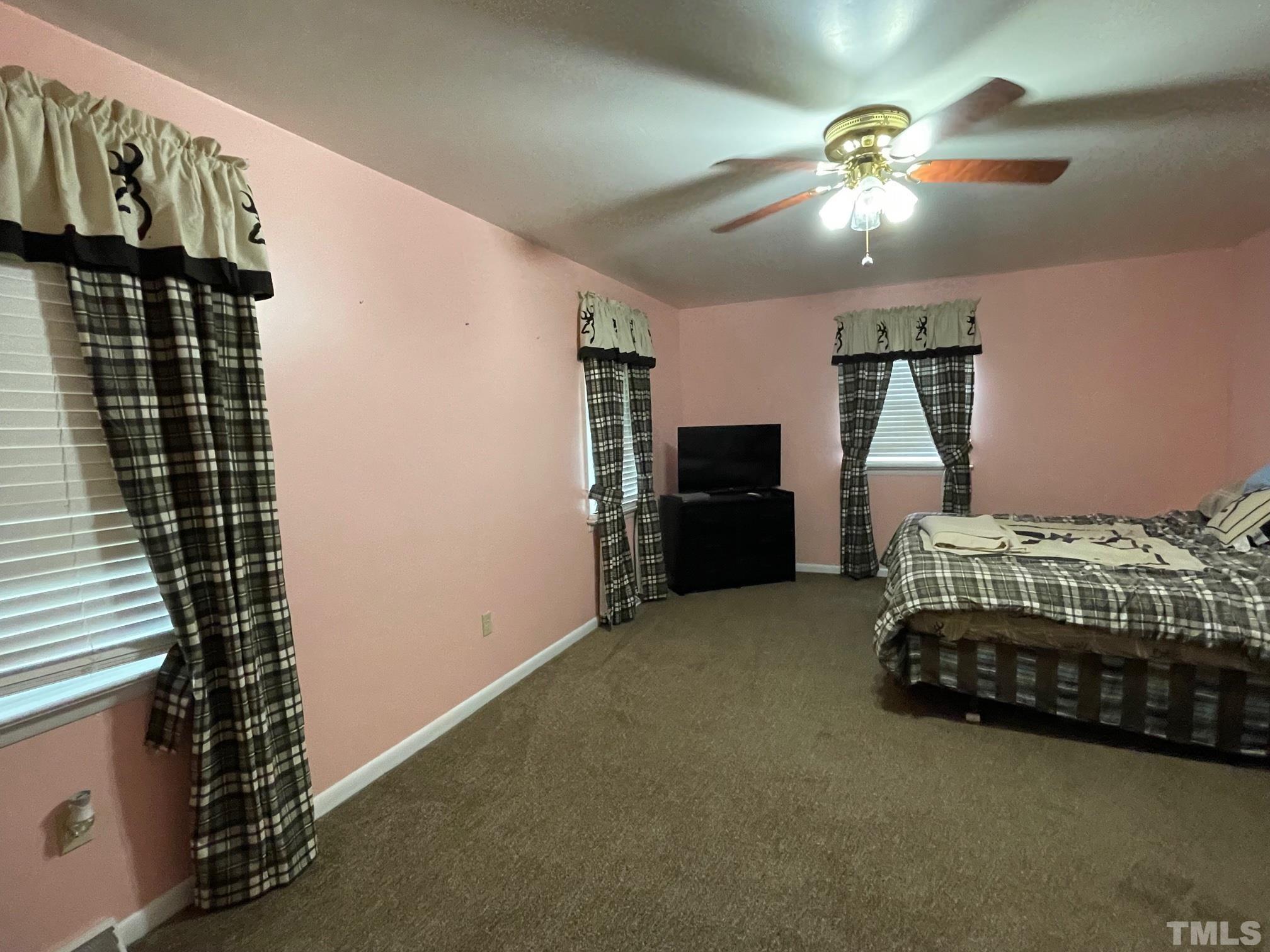 1641 Oak Grove Road Roxboro, NC 27574 - Photo 10 of 23 a bedroom with a bed and a chandelier