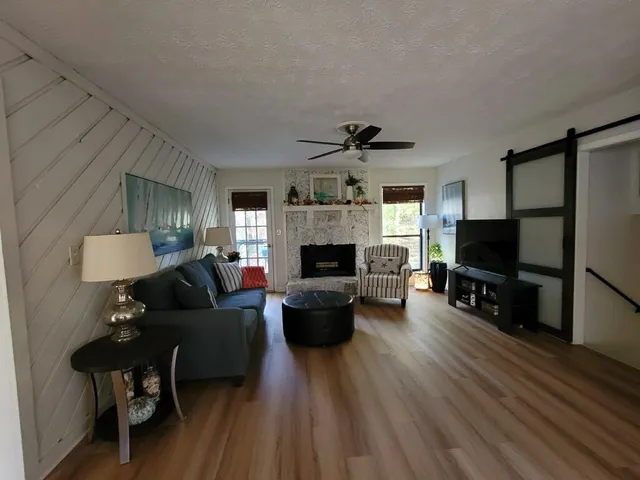 a living room with fireplace furniture and a flat screen tv