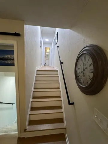 a view of entryway with wooden floor and a front door