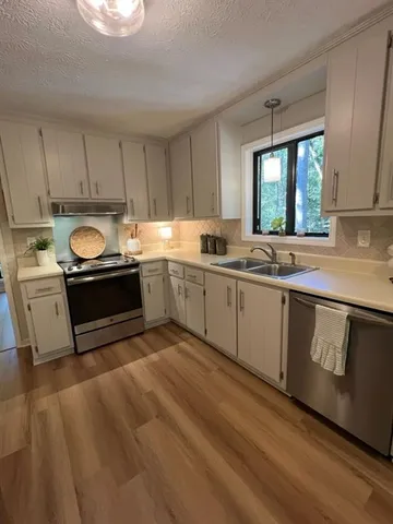 a kitchen with sink cabinets and window