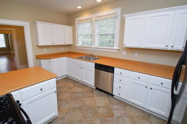 a kitchen with cabinets appliances and a window