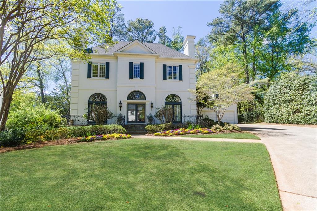 1280 West Wesley Road Northwest Atlanta, GA 30327 - Photo 1 of 1 a front view of a house with garden