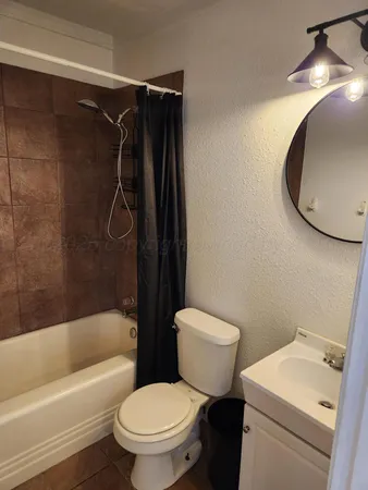 a bathroom with a toilet and a tub