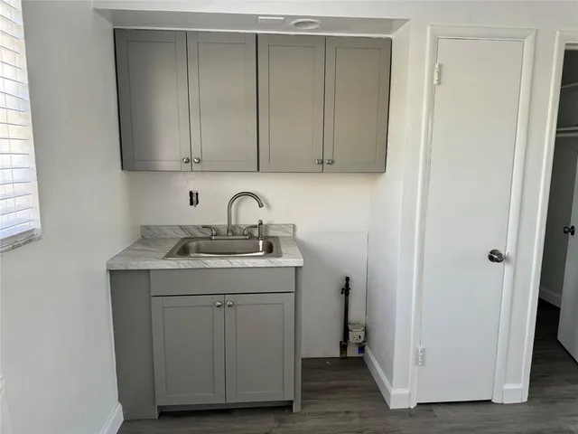a kitchen with a sink cabinets and a window