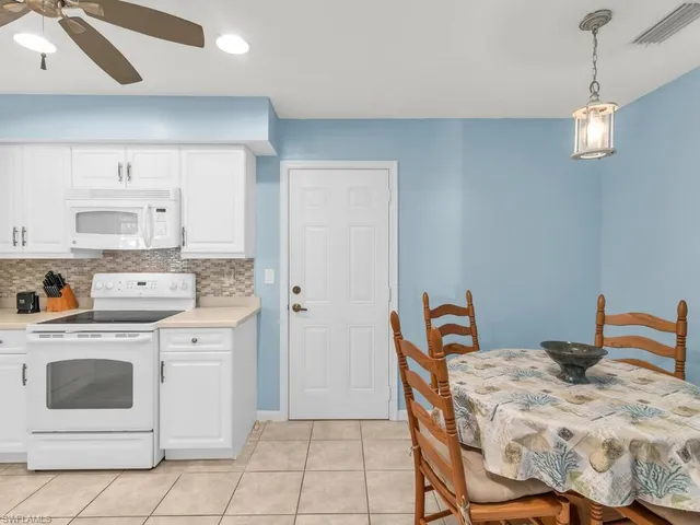 a kitchen with stainless steel appliances granite countertop a white cabinets and a stove