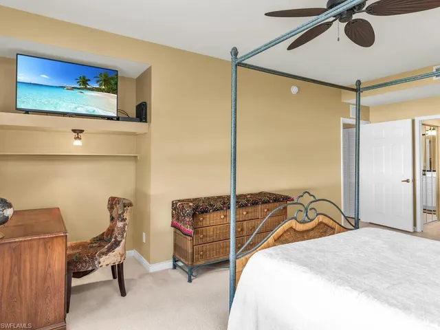 a bedroom with a bed and a flat screen tv