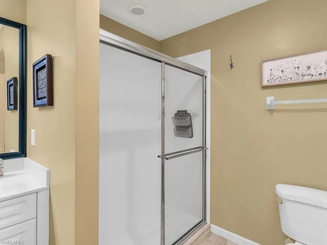 a bathroom with a shower and a toilet