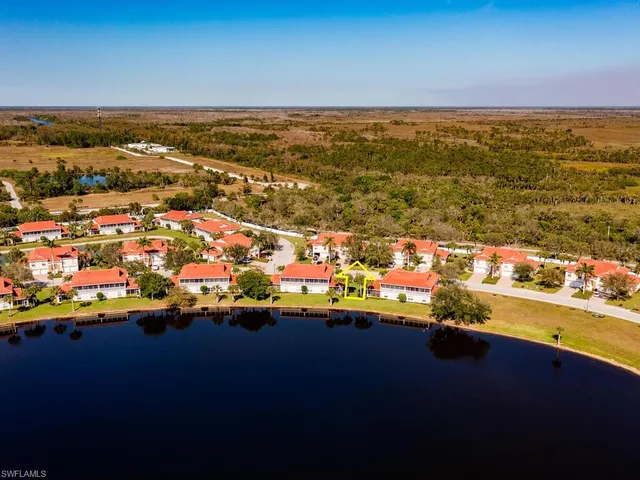 an aerial view of a house with a lake view
