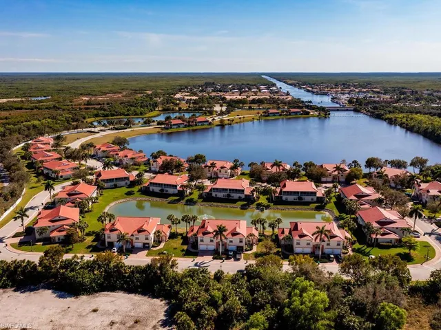 an aerial view of residential houses with outdoor space and swimming pool