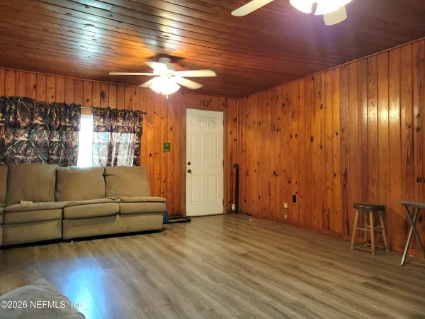 a living room with furniture and a wooden floor