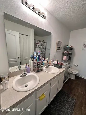 a bathroom with a double vanity sink and a mirror