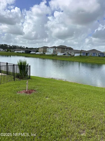 a view of a lake with houses in the back