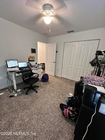 a work room with furniture and a window