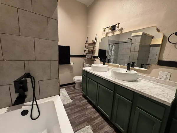 a bathroom with a double vanity sink and a mirror