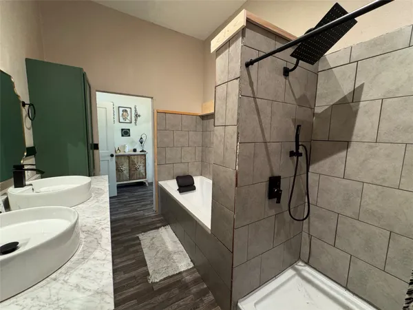 a bathroom with a bathtub and a shower