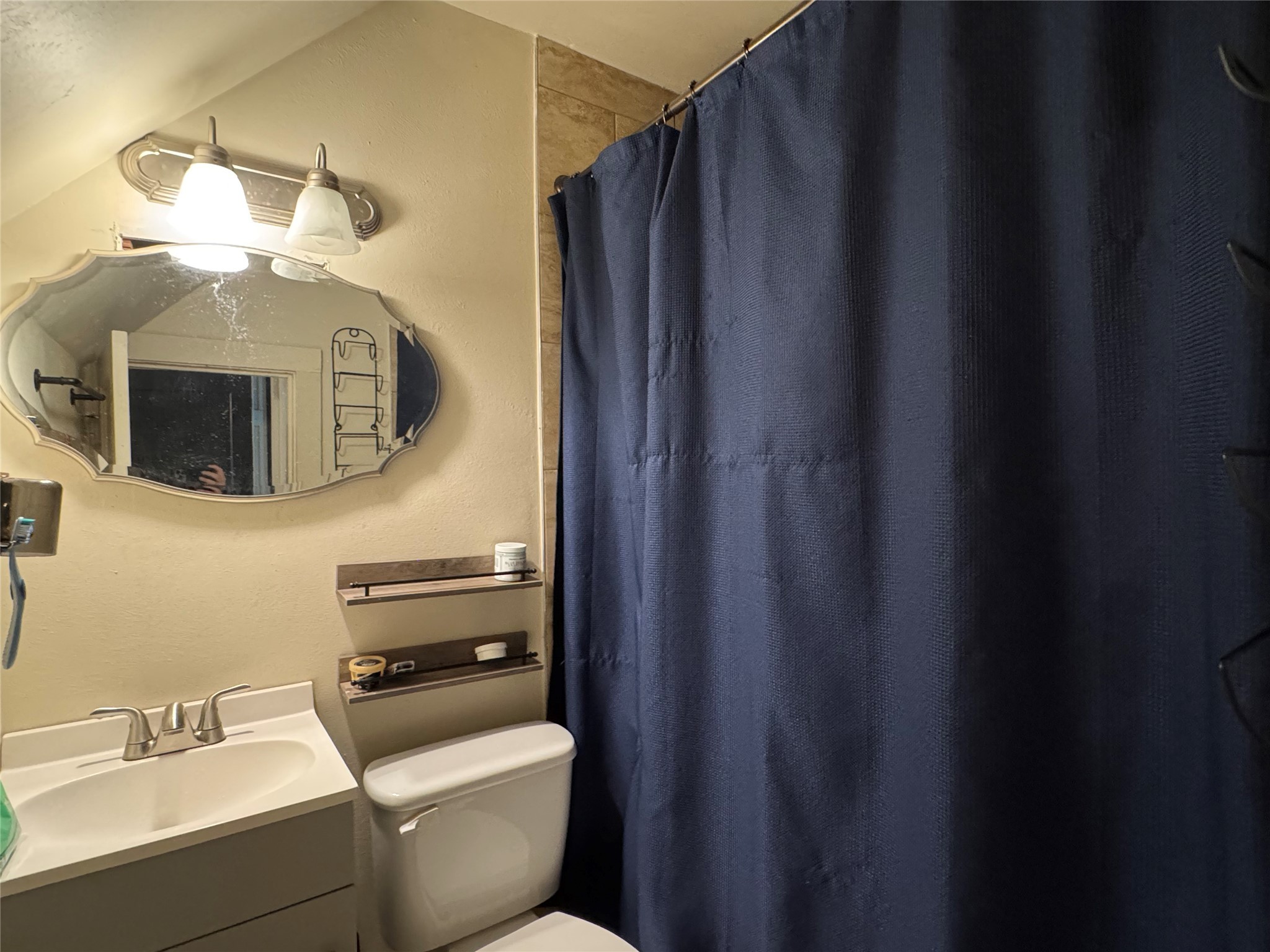 505 North 6th Street Silsbee, TX 77656 - Photo 25 of 35 a bathroom with a toilet a sink and mirror