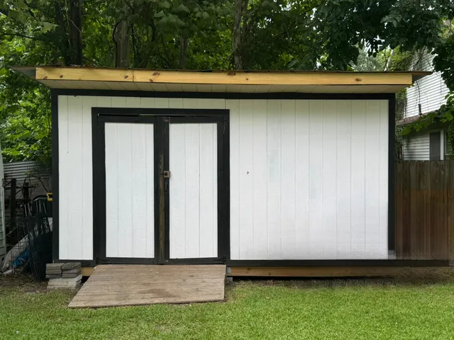 a front view of a house with a yard and shrubs
