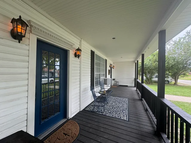 a view of a balcony with wooden floor