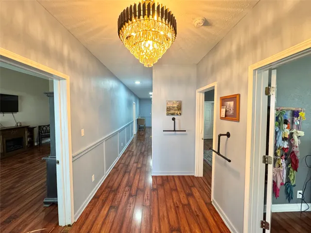 a view of hallway with wooden floor