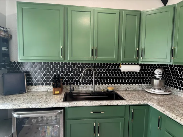 a kitchen with a sink and cabinets