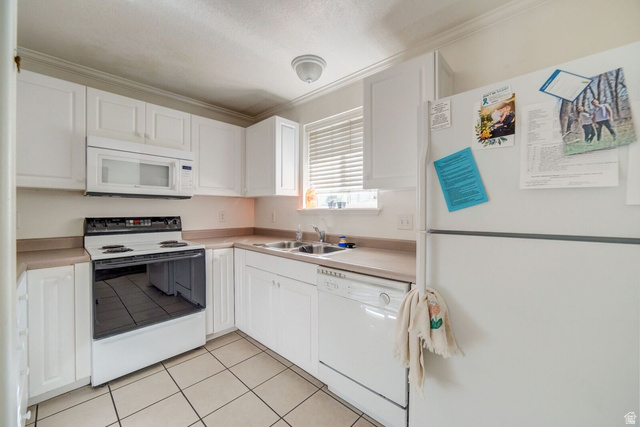 72 300 North, Unit 302 Provo, UT 84601 - Photo 2 of 16 Kitchen featuring white cabinetry, an over-the-range microwave, a white electric range, a double basin sink, and tile flooring