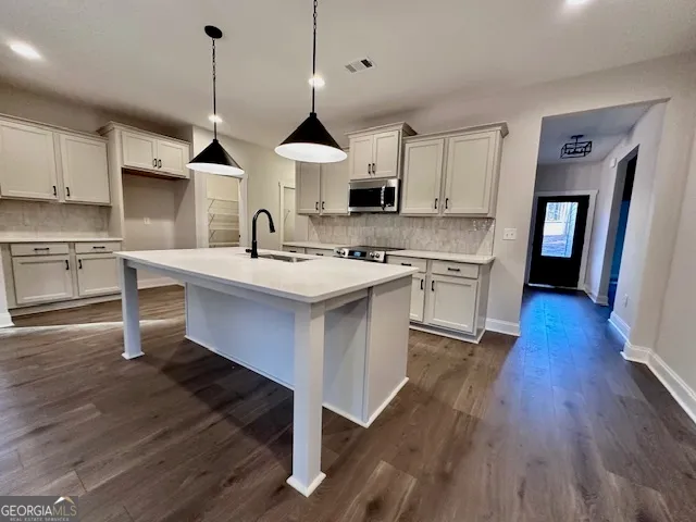 an open kitchen with wooden floor and window