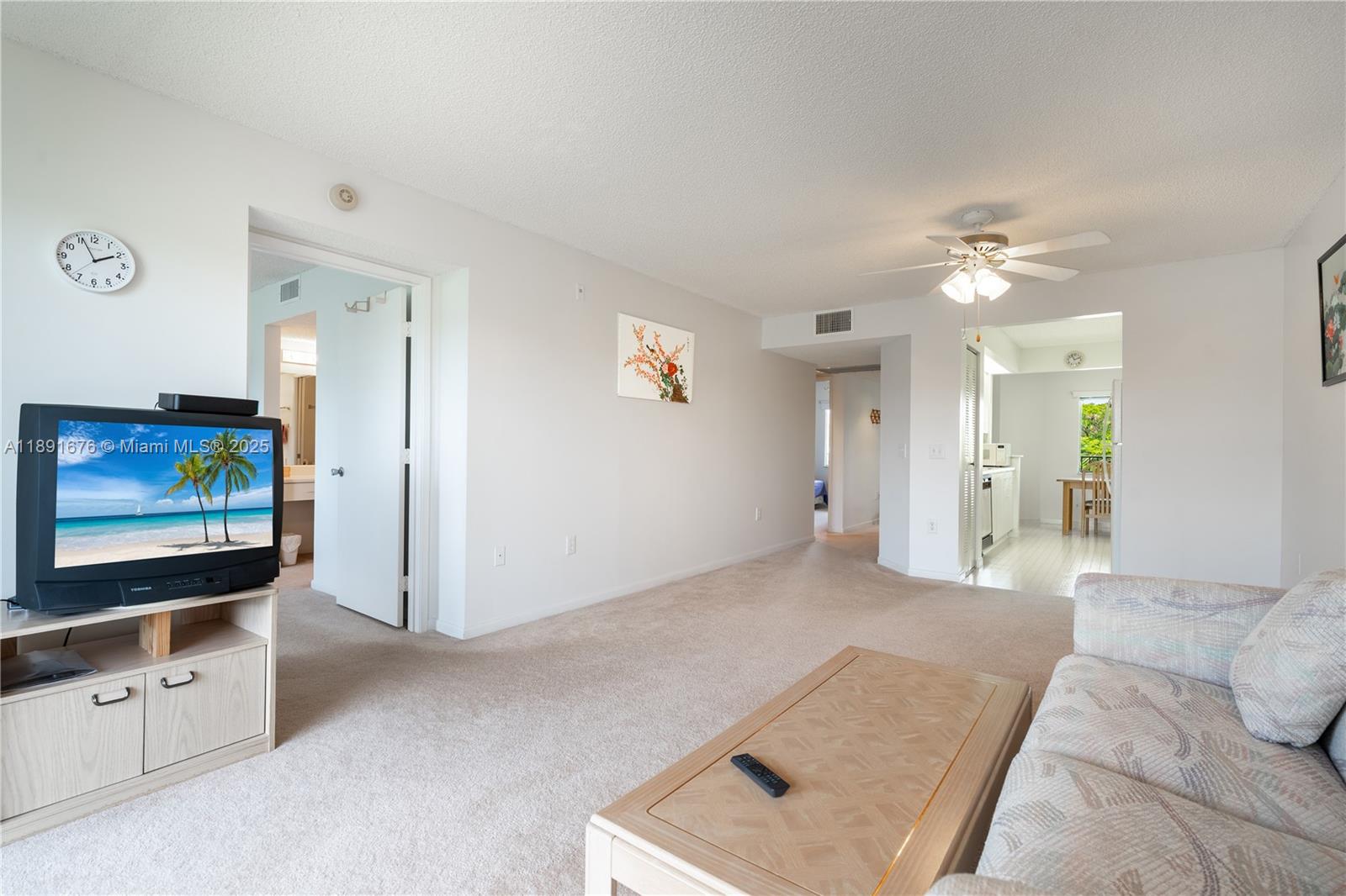 13700 Southwest 11th Street, Unit 309A Pembroke Pines, FL 33027 - Photo 15 of 31 a living room with furniture and a flat screen tv