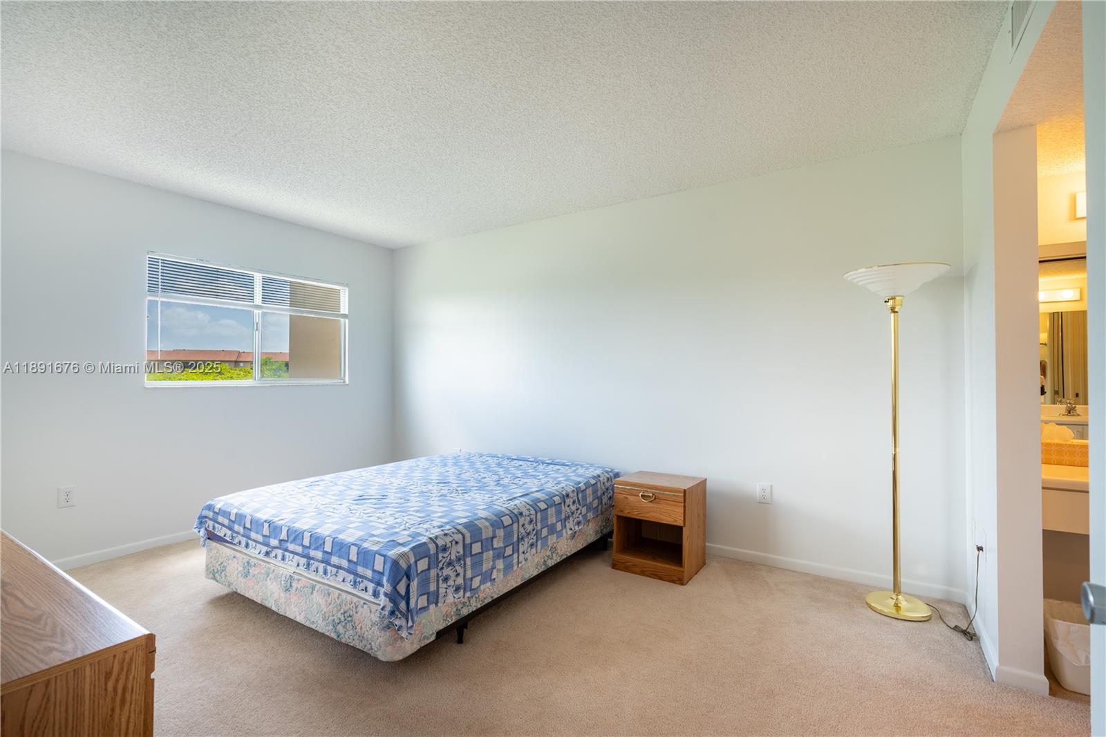 13700 Southwest 11th Street, Unit 309A Pembroke Pines, FL 33027 - Photo 17 of 31 a bedroom with a bed and painting on the wall