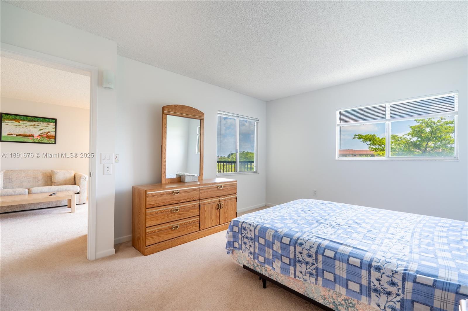 13700 Southwest 11th Street, Unit 309A Pembroke Pines, FL 33027 - Photo 19 of 31 a bedroom with a bed and a dresser