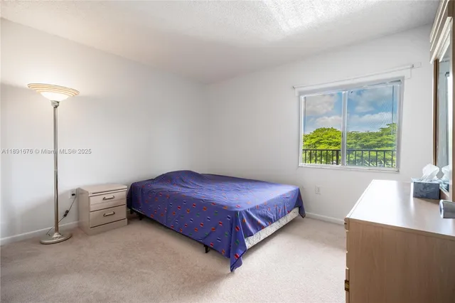 a spacious bedroom with a bed and a window