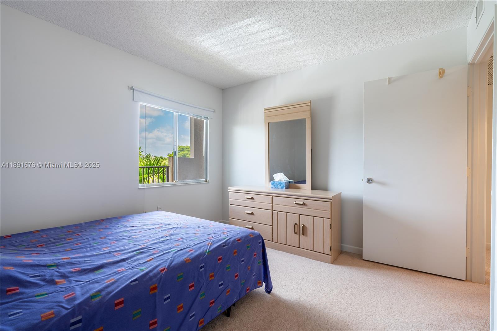 13700 Southwest 11th Street, Unit 309A Pembroke Pines, FL 33027 - Photo 27 of 31 a bedroom with a bed and a window