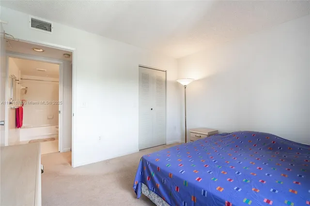 a bedroom with a bed and a mirror