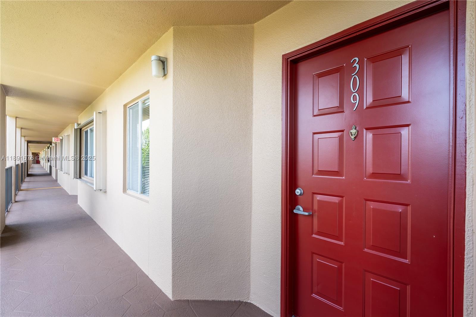 13700 Southwest 11th Street, Unit 309A Pembroke Pines, FL 33027 - Photo 29 of 31 a view of a hallway with wooden floor and entryway