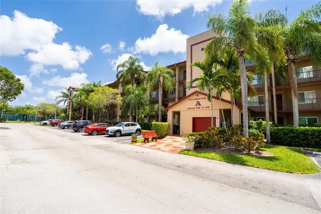 a view of a parked cars in front of a house