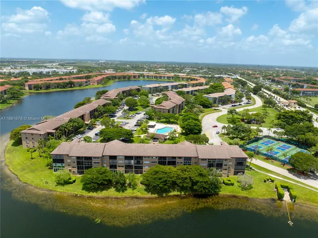 an aerial view of residential houses with outdoor space and river